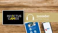 Im Vordergrund in grau/gelber Schrift auf schwarzem Grund das InvictusGames Logo, im Hintergrund Tablet und Handy mit ZMSBw Logo
